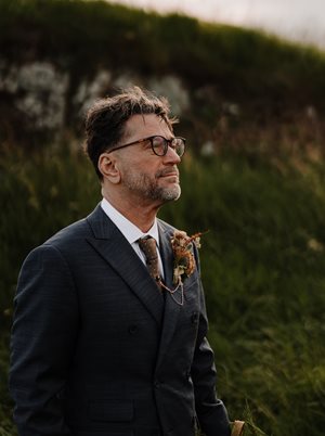 John P. Clark, recipient of the 2026 ASME IGTI Aircraft Engine Technology Award, standing outdoors in a dark suit with a boutonniere, looking into the distance.