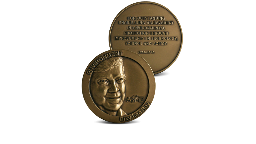 A bronze medal with a relief portrait of a man on the obverse, surrounded by text "ENVIRONMENT" and "Dixy Lee Ray", with "ASME" logo. The reverse side has embossed text "FOR OUTSTANDING ENGINEERING AC